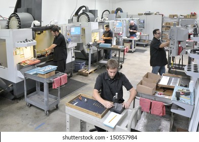 CNC machine shop with lathes, technicians and workers