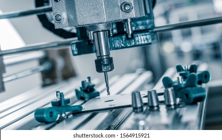 CNC milling machine cutting aluminium  part.CNC milling machine working on  detail. - Shutterstock ID 1564915921