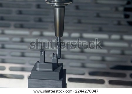 The CNC milling machine cutting the graphite electrode parts with solid ball end mill. The mold and die manufacturing process by CNC machining center.