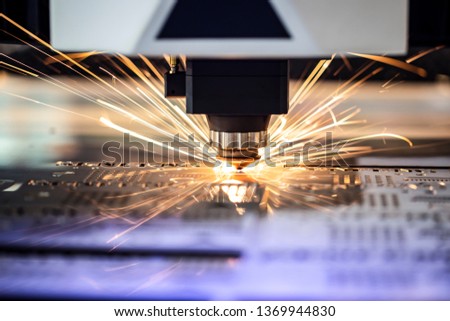 Cnc milling machine. Processing and laser cutting for metal in the industrial area with coolant. Industrial exhibition of machine tools.