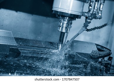 The CNC milling machine rough cutting the mold and die parts with liquid coolant method. The mold and die manufacturing process by CNC machining center.