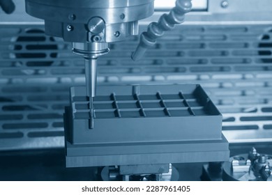 The CNC milling machine rough cutting the graphite electrode parts with solid ball end mill. The mold and die manufacturing process by CNC machining center. - Shutterstock ID 2287961405