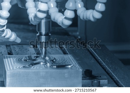 The CNC milling machine rough cutting the injection mold parts by indexable tools in the light blue scene. The mold and die manufacturing process by machining center with the solid endmill tools.