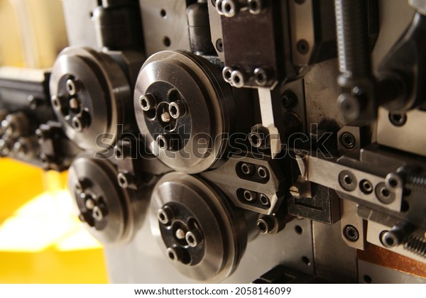 CNC spring\
making machine.  Industrial\
machine.