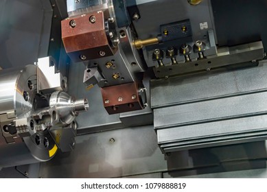 The CNC turning or lathe machine cutting the thread at the end of metal cone shape part. High technology manufacturing process. - Shutterstock ID 1079888819