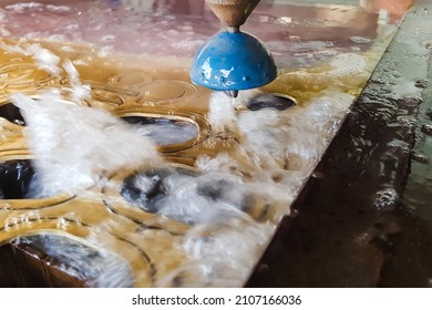 CNC water jet cutting machine is a modern industrial technology for cutting any material - Powered by Shutterstock