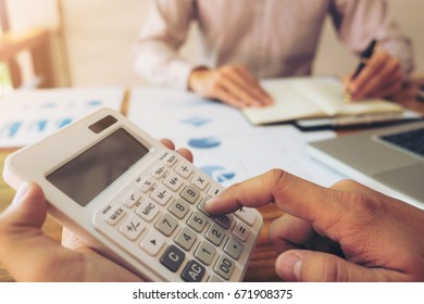 Co working conference, Business team meeting present, investor colleagues discussing new plan financial graph data on office table with laptop and calculator, Finance, accounting, investment.