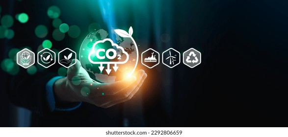 CO2 emission reduction concept, businessman with environmental technology Icons, global warming, sustainable development, renewable energy business. climate change, carbon capture, storage, reuse