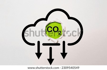 CO2 reducing icon on green background for decrease CO2 , carbon footprint and carbon credit to limit global warming from climate change and Kyoto protocol concept.