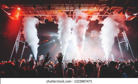 Co2 Smoke Cannons Silhouette Of Crowd At A Music Festival 
Silhouettes Of Concert Crowd In Front Of Bright Stage Lights. Dark Background, Smoke, Concert  Spotlights