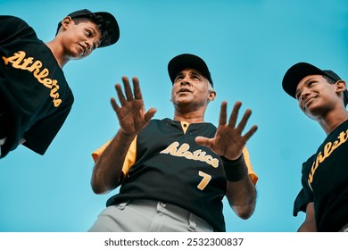 Coach, boys and serious with baseball player in conversation for team building, support or motivation. People, sports and low angle with game planning for practice, training and tournament or match - Powered by Shutterstock