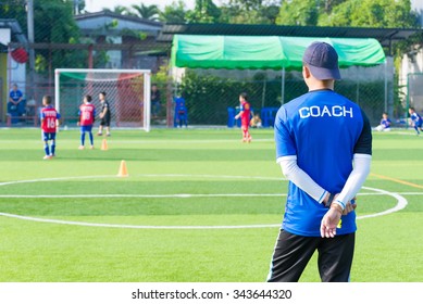 Coach Is Coaching Children Training In Soccer Team