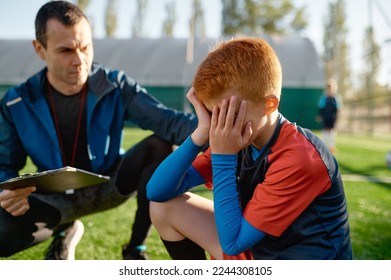 Coach comforting crying little soccer player after missed goal - Powered by Shutterstock