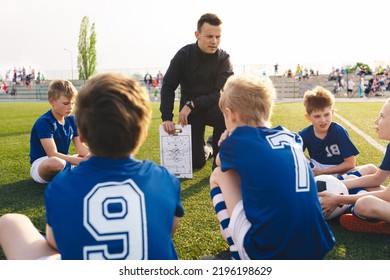 Coach explains a game strategy using board. Young coach teaching kids on football field. Football coach coaching children. Soccer football training session for children. Football tactic education
 - Powered by Shutterstock