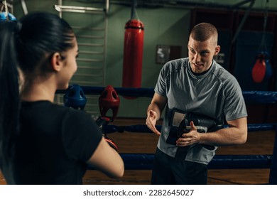 A coach is giving instruction to a sportswoman before training - Powered by Shutterstock