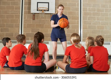 Coach Giving Team Talk To Elementary School Basketball Team - Powered by Shutterstock