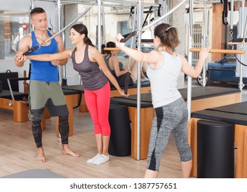 coach with a group in the modern gym doing exercises