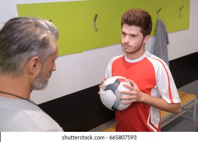 Coach And Player Talking In Changing Room