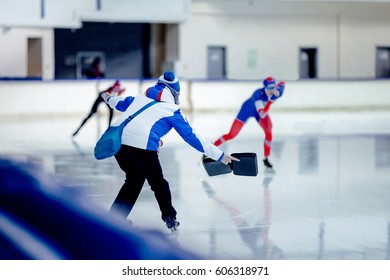 coach speed skaters shows result on competitions in speed skating - Powered by Shutterstock