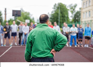 Coach stands in front of his students and gives instructions before training. - Powered by Shutterstock