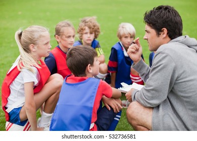 Coach Talking To Childrens Soccer Team