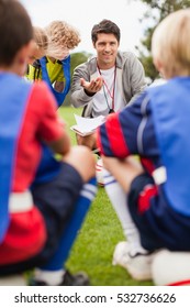 Coach Talking To Childrens Soccer Team