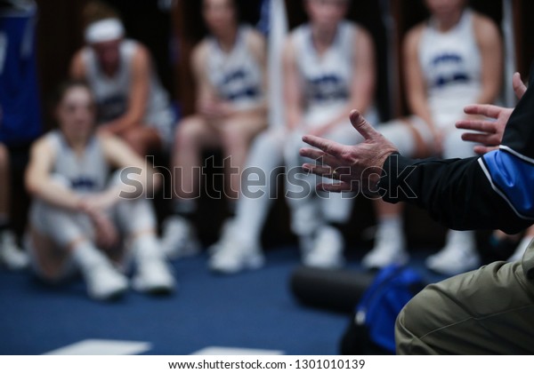 A coach talks
to his players during
halftime