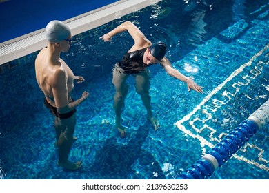 Coach Telling To Young Lady How To Swim