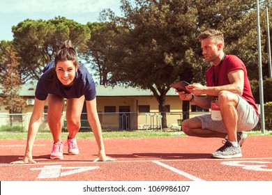 the coach times and gives tips for the ride to his young runner athlete with the tablet - Powered by Shutterstock