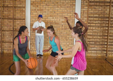 Coach Watching The High School Kids Playing Basketball In The Court