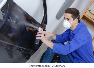 Coachbuilder Painting A Car Door