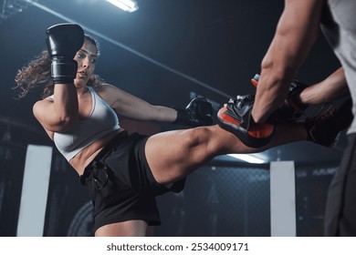 Coaching, boxing and fitness with woman in gym for martial arts competition, challenge and sports center. Personal trainer, mentor and mma event with people for kickboxing, fighter and self defense - Powered by Shutterstock