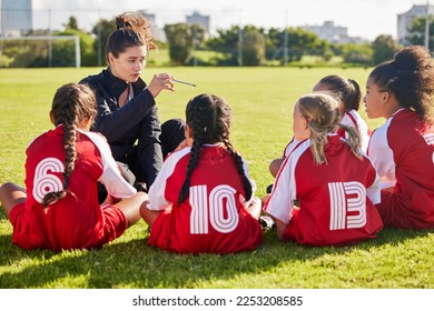 Coaching, exercise or coach with children for soccer strategy, training and team goals in Canada. Team building, teamwork and woman planning group of girl on football field for game, match or workout - Powered by Shutterstock