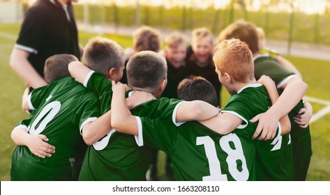 Coaching Youth Sports. Group Of Children In Soccer Team. School Football Coach’s Pregame Speech. Young Boys United In Football Team