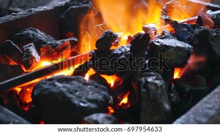 Coal with burning fire and iron.