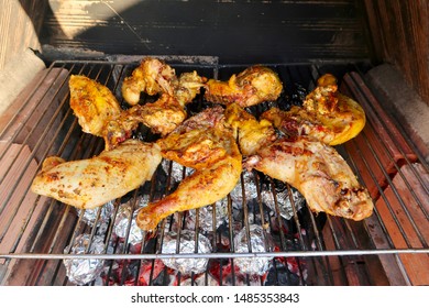 Coal Fire Bbq Grill With Tasty Barbecue Chicken, Aluminium Foil Baking Potatoes And Vegetables Cooking In Marbella, Spain                                