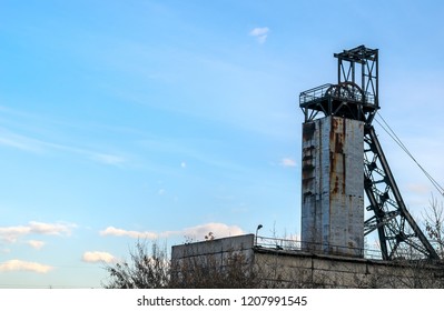 Coal mine with wheels. Colliery against the blue sky with clouds - Shutterstock ID 1207991545