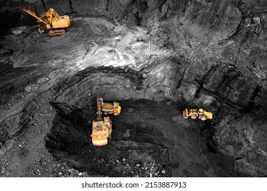 Coal mining in an open pit. Mining excavator loads coal in haul truck in quarry. Excavator digging in an open pit coal mine. Tipper truck hauling minerals from open-pit. Heavy machinery in opencast. 