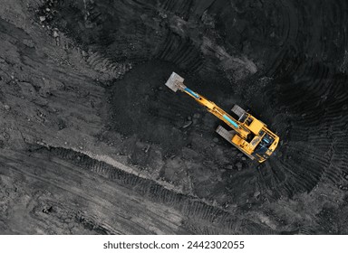 Coal mining in an open pit. Mining excavator loads coal in haul truck in quarry. Excavator digging in an open pit coal mine. Tipper truck hauling minerals from open-pit. Heavy machinery in opencast. 
