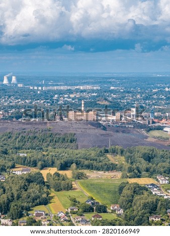 Coal mining operations creating large waste dumps near residential areas and a power plant