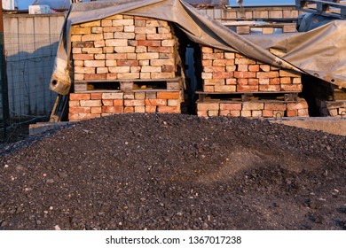 Coal Mound And Bricks Stacked In A Row - Building