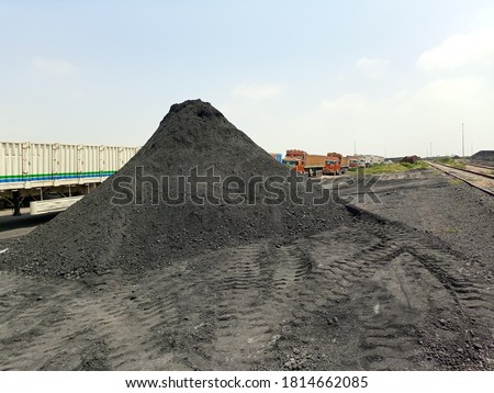 A coal yard with material heap. There is a line of truck in background  Stock photo © 