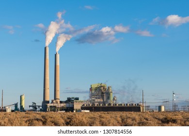 A Coal-fired Electrical Power Plant With Smokestacks Emitting Plumes Of Smoke In The Southwestern United States