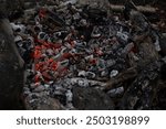 Coals in the fire. Hot coals. Details of a campfire in the woods. Stones around a campfire.