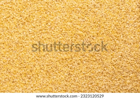 Coarse bulgur, also called burghul, surface, from above. Cracked and parboiled wheat foodstuff, and common ingredient in cuisines of West Asia and Mediterranean Basin, with a light and nutty flavor.