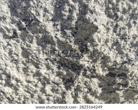 Coarse chiseled limestone texture background, rustic split face sand-beige stone aggregate cement surface with intense shadow play for architectural 3D rendering
