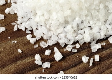 Coarse salt on a old wooden table, closeup