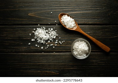 Coarse sea salt in a wooden spoon and on a vintage table. Traditional medicine concept - Powered by Shutterstock