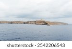 Coast of Comino with Saint Mary tower. Malta. It is a large bastioned watchtower on the island of Comino in Malta. It was built in 1618, the fifth of six Wignacourt towers.