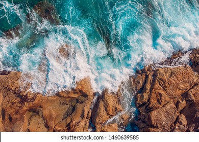 Coast of desert island with blue turquoise water beats on rocky reef Malta. Aerial top view